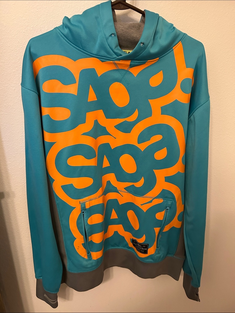 Saga Outerwear Men's Teal Hoodie with Bold Orange Logo